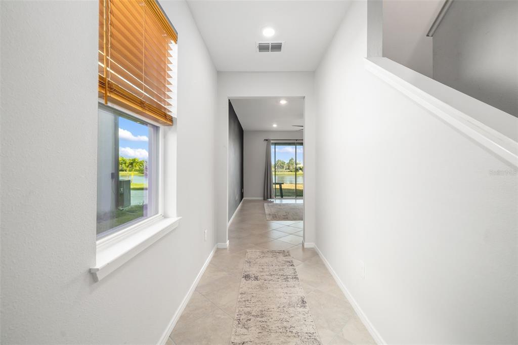 9406 Lamine Way Parrish, FL 34219 - Photo 50 of 74 a view of a hallway with wooden floor and a window