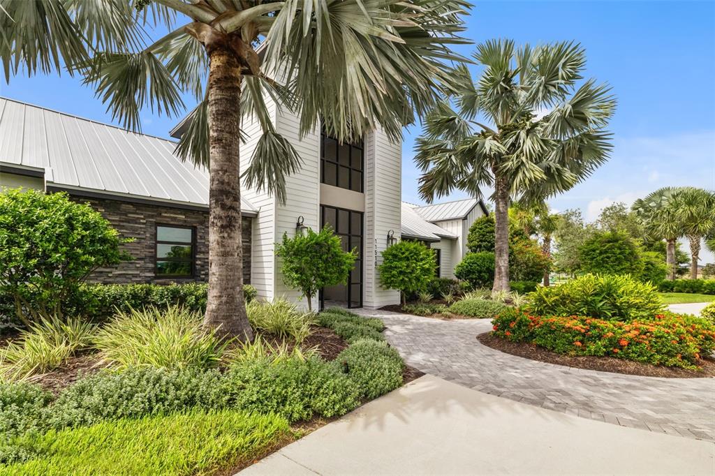 9406 Lamine Way Parrish, FL 34219 - Photo 57 of 74 a front view of multi story residential apartment building with yard and green space
