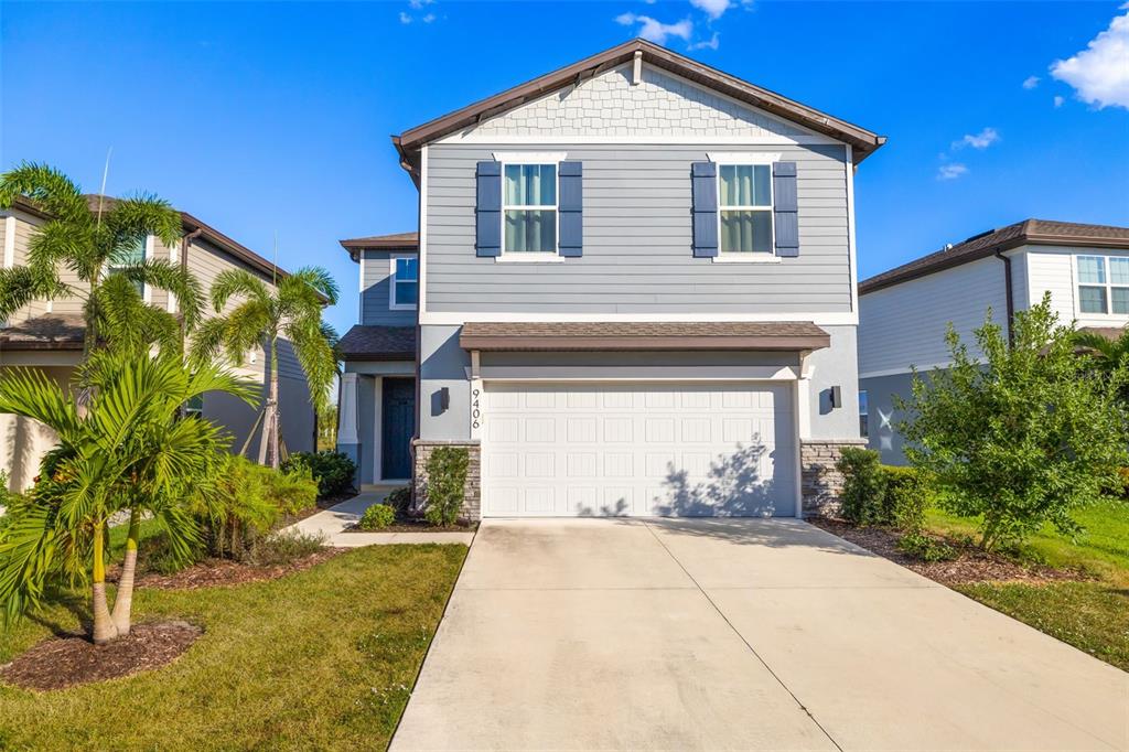 9406 Lamine Way Parrish, FL 34219 - Photo 70 of 74 a front view of a house with a yard and garage
