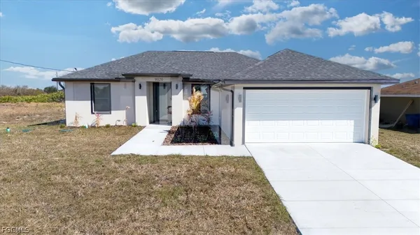 a front view of a house with a yard and garage