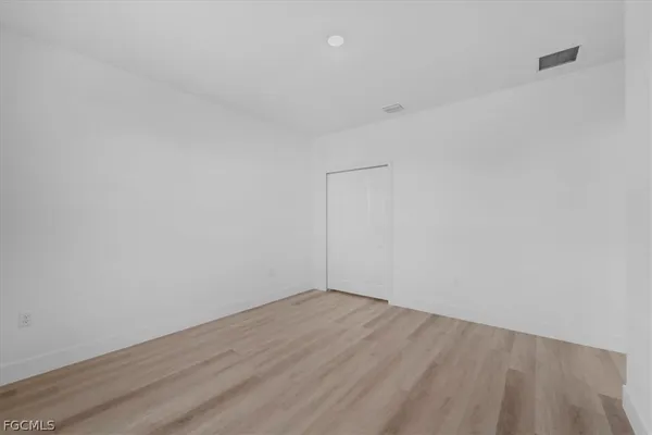 a view of a room with wooden floor
