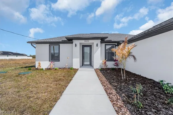 a front view of a house with a yard