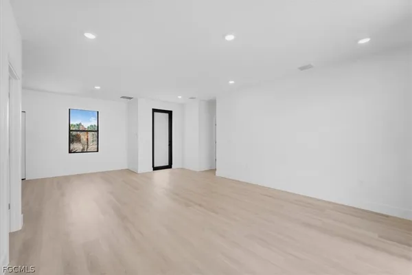 an empty room with windows and entrance