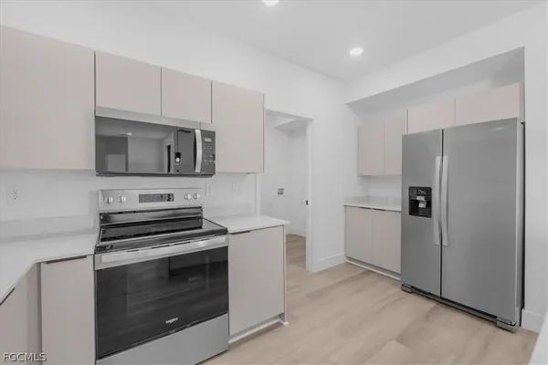 a kitchen with a refrigerator stove and microwave