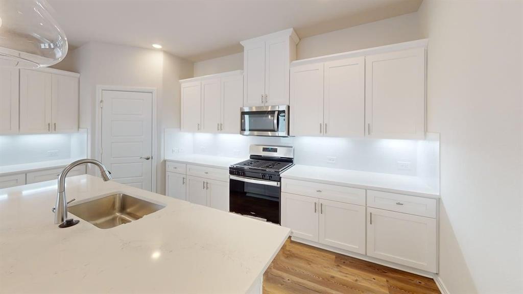 1840 Rosedale Avenue Van Alstyne, TX 75495 - Photo 4 of 24 Kitchen featuring an expansive island with an undermount sink and gooseneck faucet