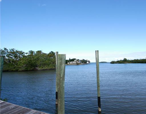 146 South Sewalls Point Road Stuart, FL 34996 - Photo 6 of 8 a view of a lake with wooden stairs and bridge