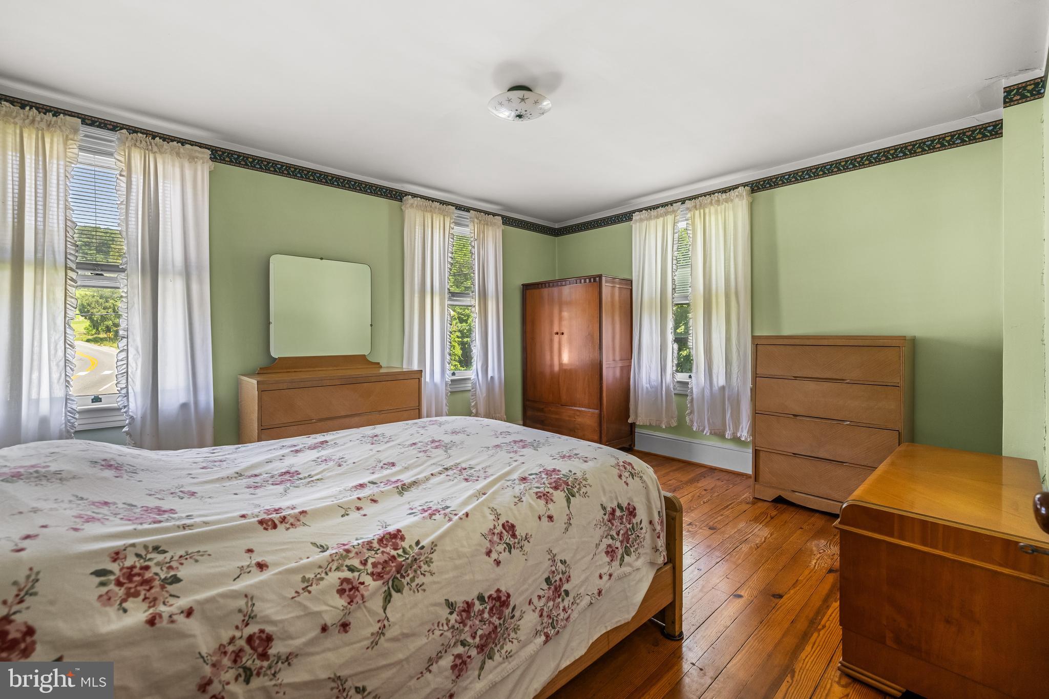 1053 Freeland Road Freeland, MD 21053 - Photo 24 of 31 a bedroom with a bed and a dresser with mirror