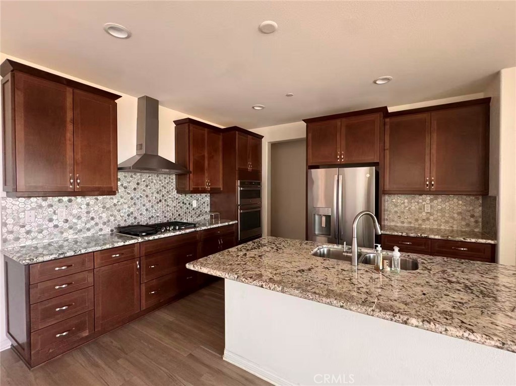 15767 Ralph Lane Fontana, CA 92336 - Photo 3 of 13 a kitchen with stainless steel appliances granite countertop a sink stove and refrigerator