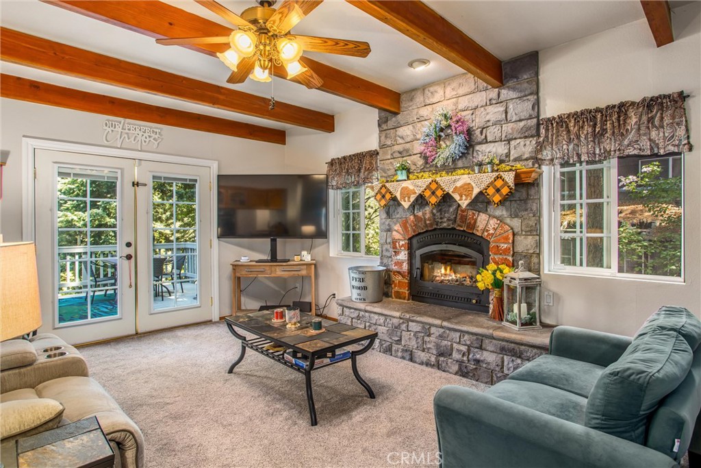 6180 Cedar Avenue Angelus Oaks, CA 92305 - Photo 14 of 31 a living room with furniture a flat screen tv and a fireplace