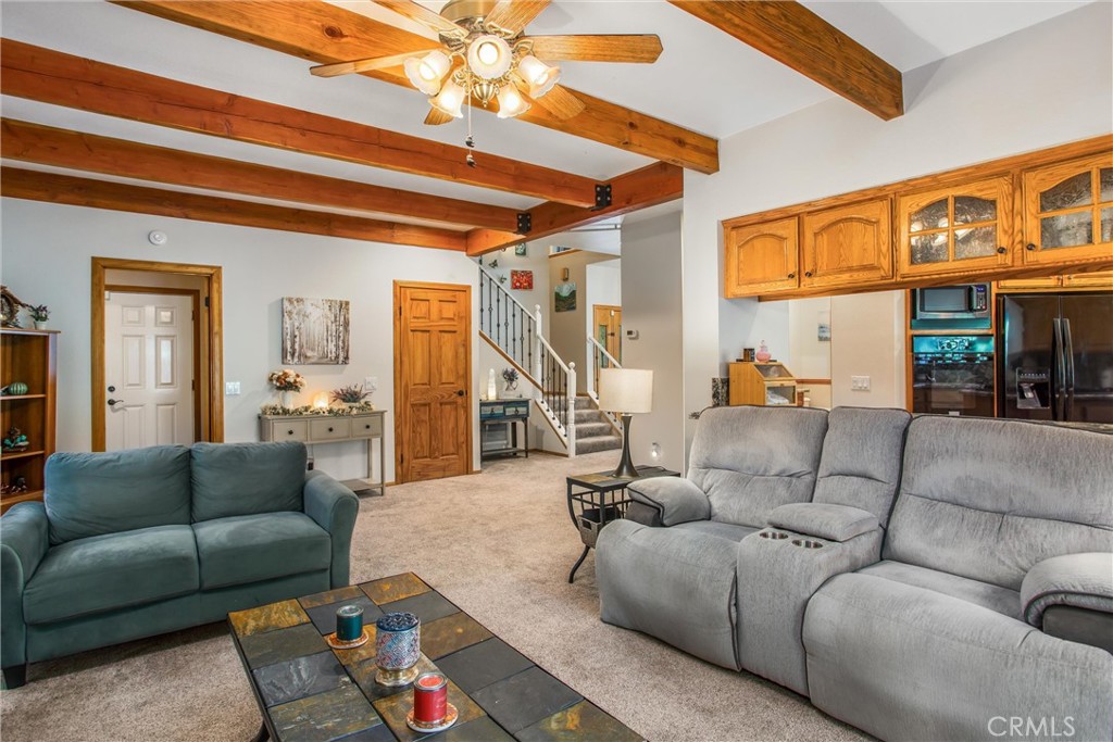 6180 Cedar Avenue Angelus Oaks, CA 92305 - Photo 15 of 31 a living room with furniture a rug and a chandelier