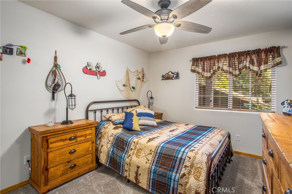 6180 Cedar Avenue Angelus Oaks, CA 92305 - Photo 20 of 31 a bedroom with a bed and a chandelier