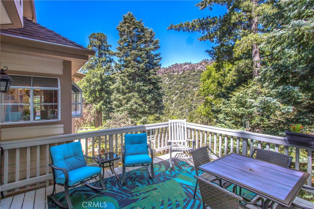 6180 Cedar Avenue Angelus Oaks, CA 92305 - Photo 2 of 31 a view of a chair and table on the deck
