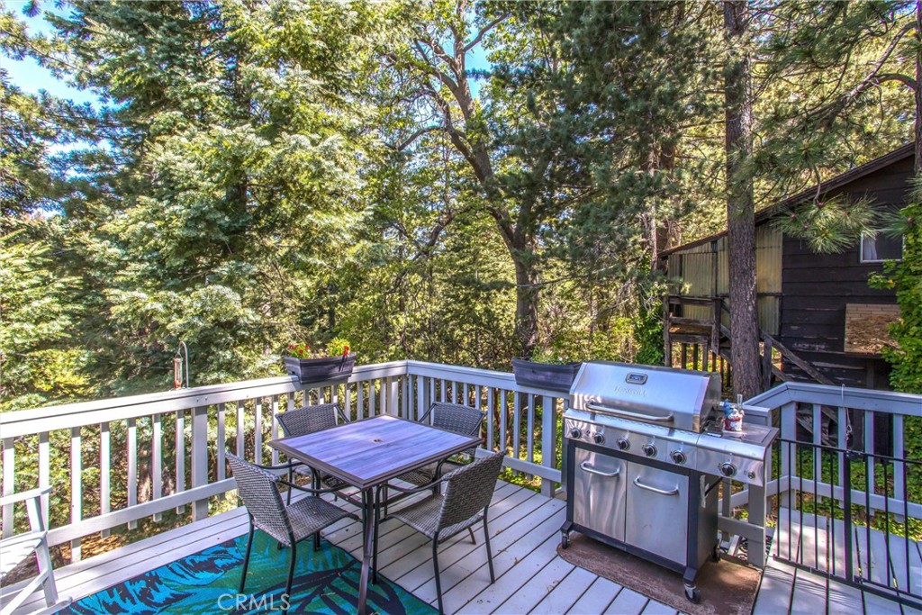 6180 Cedar Avenue Angelus Oaks, CA 92305 - Photo 26 of 31 a view of a deck with furniture and a yard