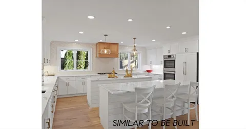 a view of a kitchen with kitchen island a sink stainless steel appliances and cabinets