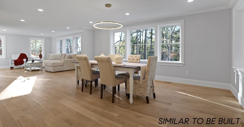 10 Webber Avenue, Unit 4D Bedford, MA 01730 - Photo 6 of 17 a view of a dining room with furniture and wooden floor