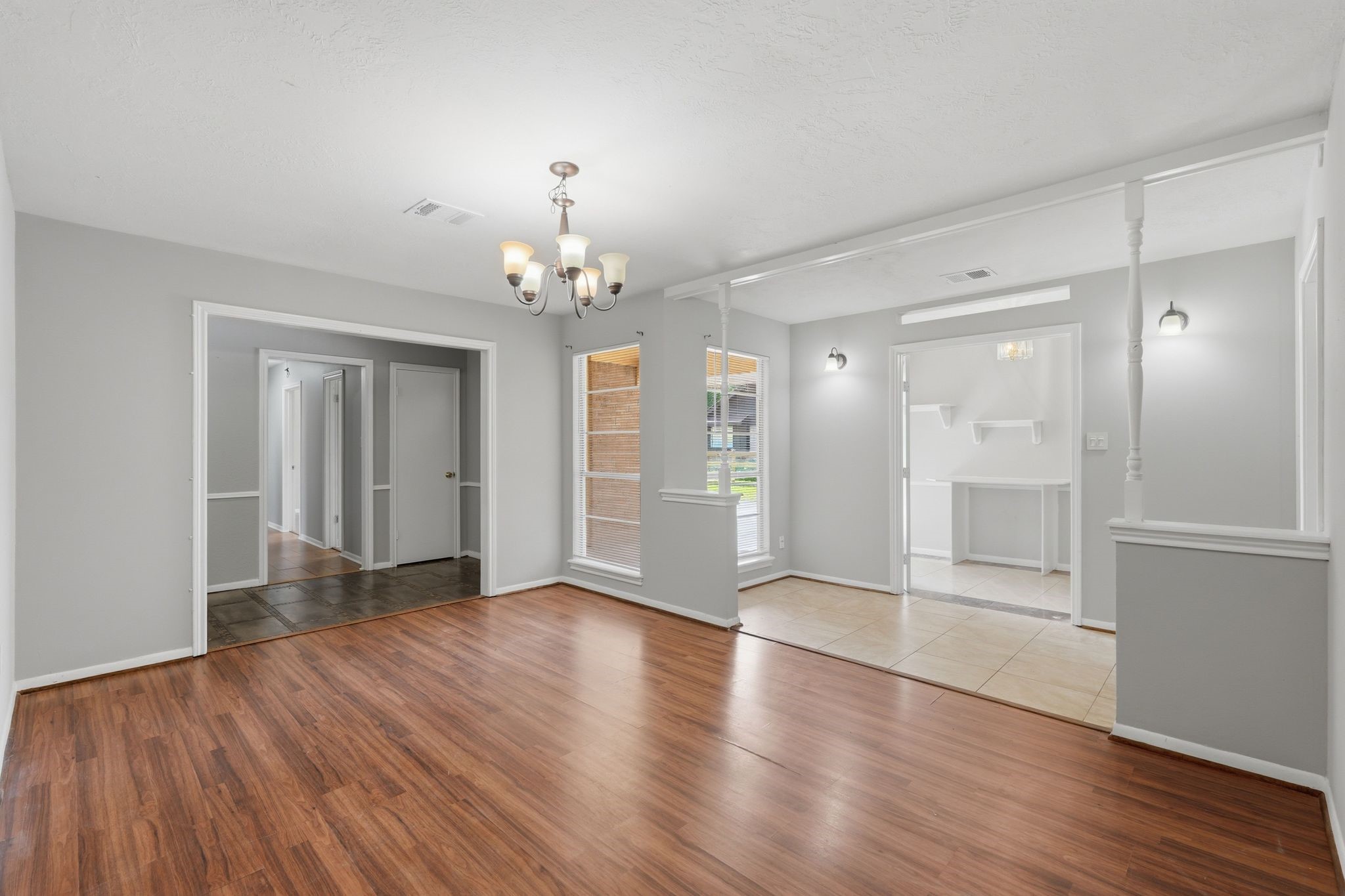 25611 Timberlane Drive Spring, TX 77386 - Photo 7 of 38 a view of an empty room with wooden floor and a kitchen