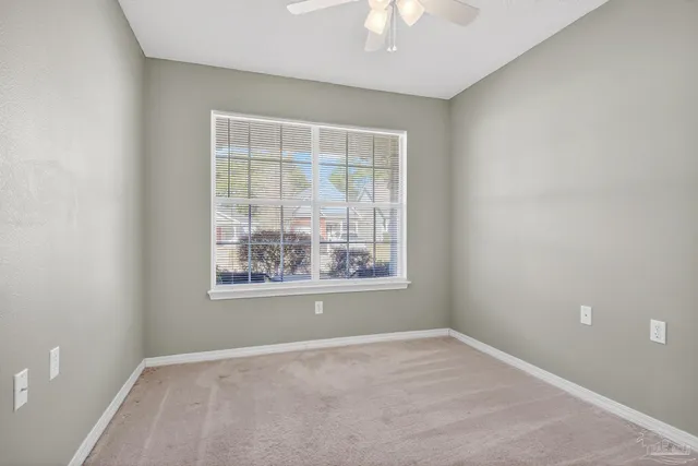 an empty room with closet and a bathroom