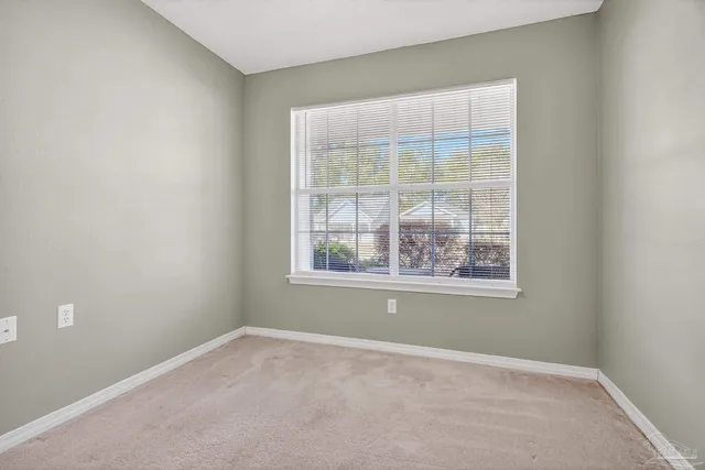 an empty room with closet and a bathroom