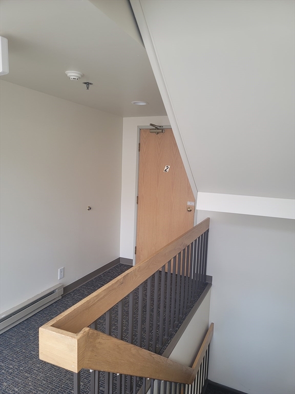 24 Corey Street, Unit 201 Everett, MA 02149 - Photo 7 of 9 a view of staircase with railing and white walls