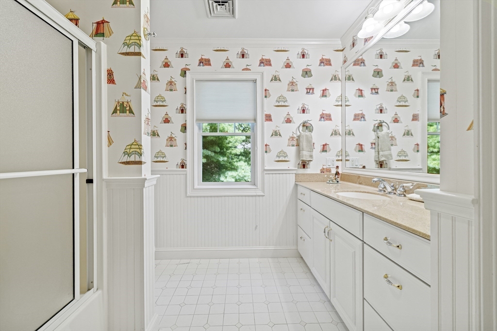 58 The Hacking Circle Mashpee, MA 02649 - Photo 18 of 37 a bathroom with a granite countertop sink a toilet and a shower curtain