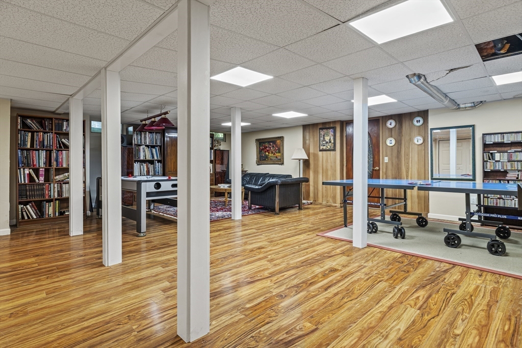 58 The Hacking Circle Mashpee, MA 02649 - Photo 26 of 37 a living room with furniture a bookshelf and wooden floors
