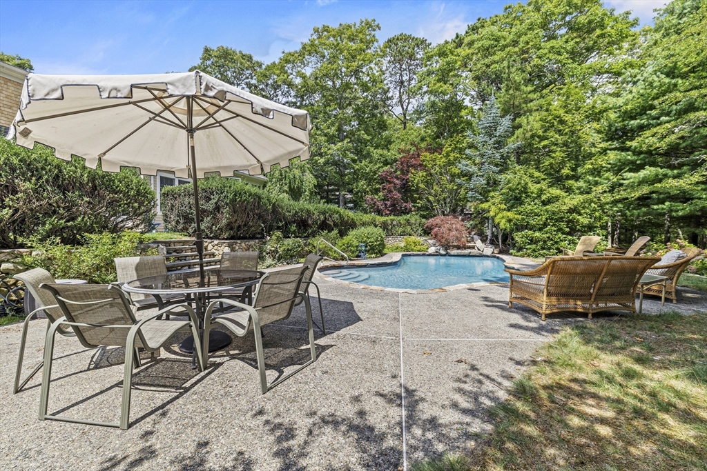58 The Hacking Circle Mashpee, MA 02649 - Photo 35 of 37 an outdoor space with patio and white umbrellas