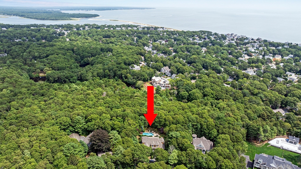 58 The Hacking Circle Mashpee, MA 02649 - Photo 37 of 37 a aerial view of a houses with a lush green forest