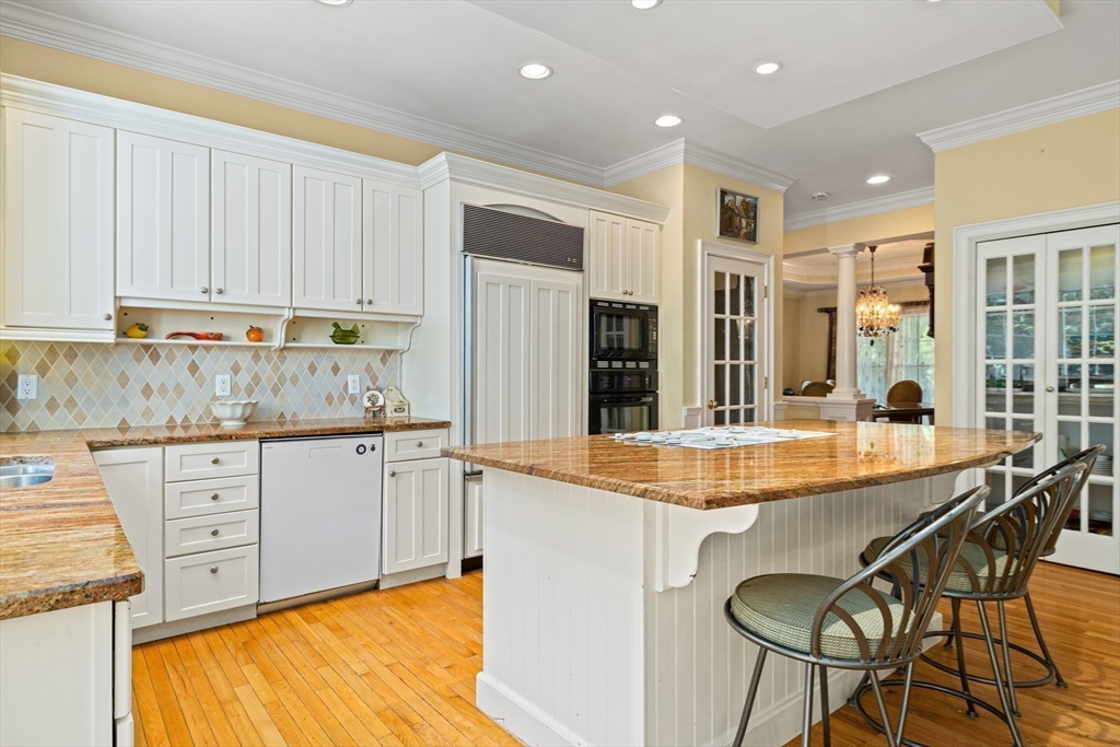 58 The Hacking Circle Mashpee, MA 02649 - Photo 5 of 37 a kitchen with granite countertop a sink and white cabinets