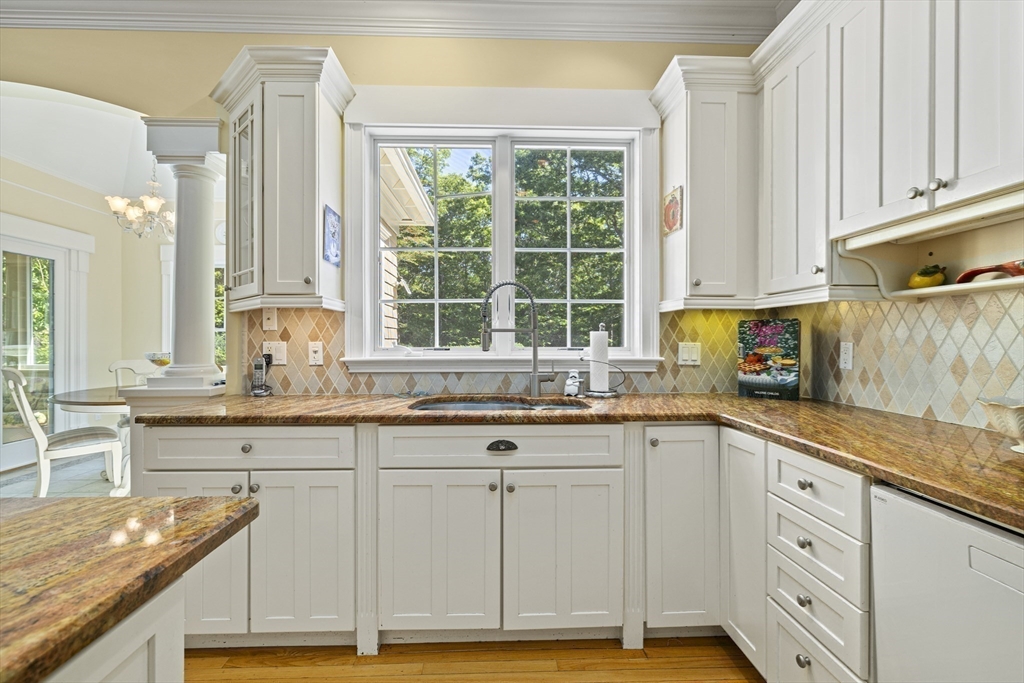 58 The Hacking Circle Mashpee, MA 02649 - Photo 6 of 37 a kitchen with granite countertop a sink and white cabinets