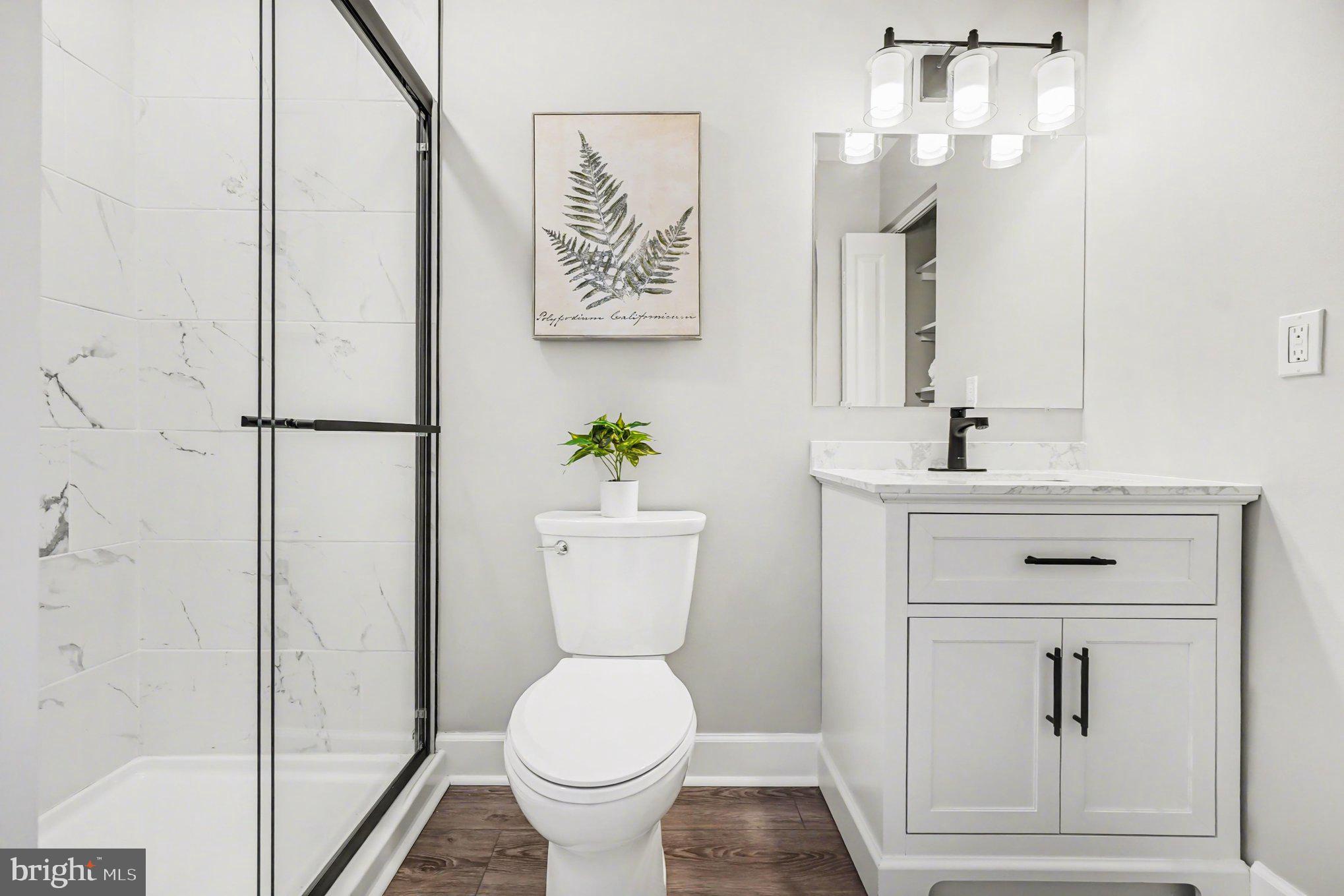 32 Romanoff Court Baltimore, MD 21234 - Photo 14 of 26 a white toilet sitting next to a bathroom sink