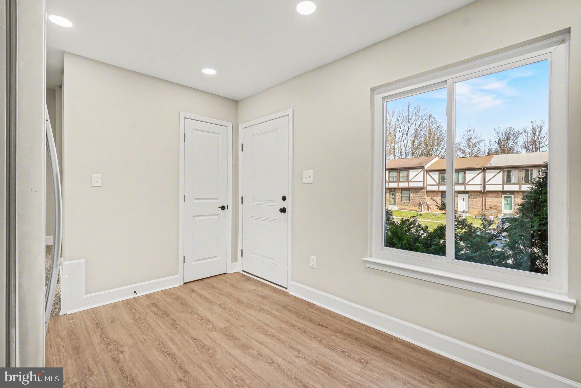 32 Romanoff Court Baltimore, MD 21234 - Photo 6 of 26 a view of empty room with wooden floor and fan