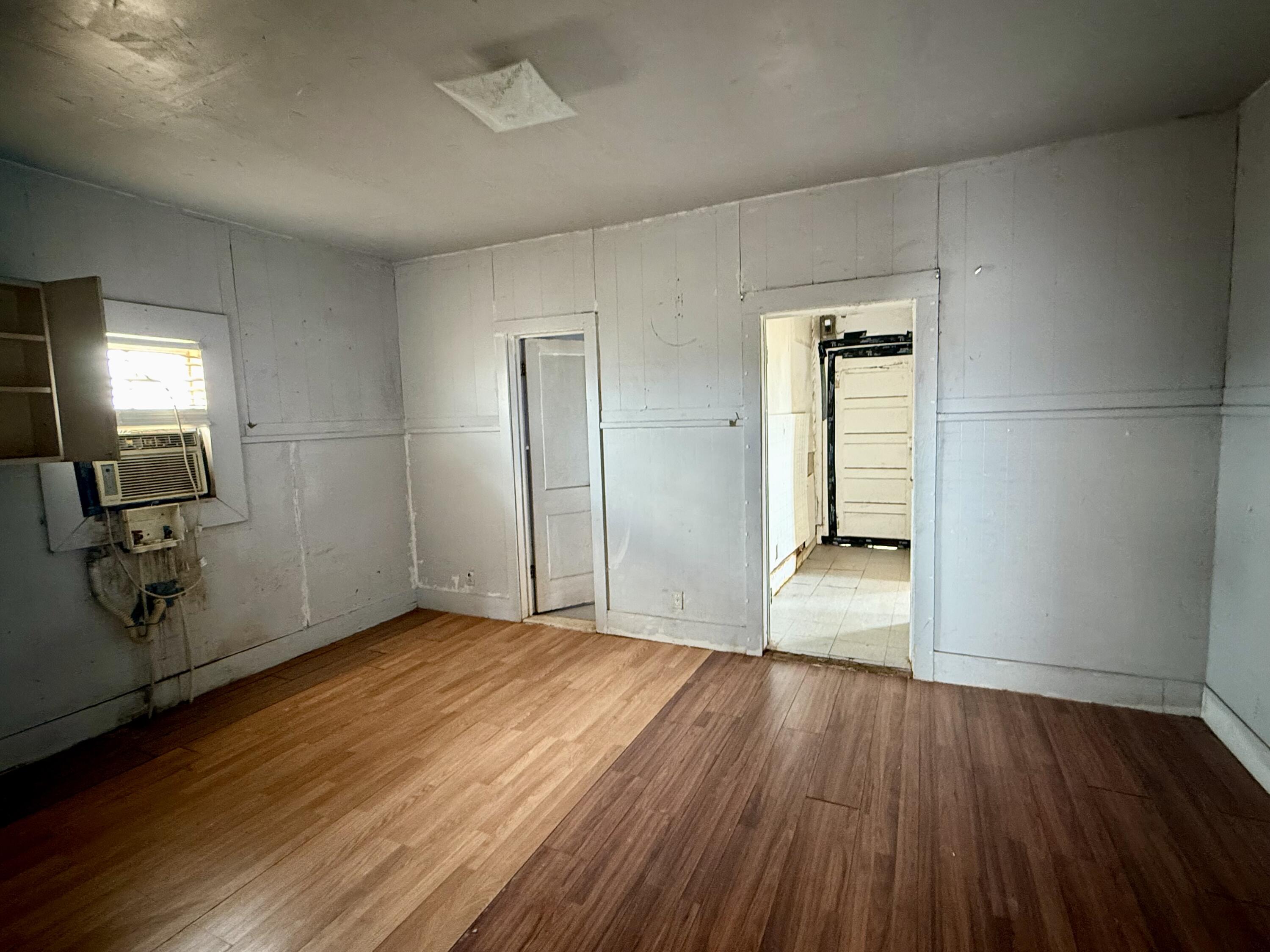2833 East 53rd Street Lubbock, TX 79404 - Photo 12 of 30 wooden floor in an empty room with a window