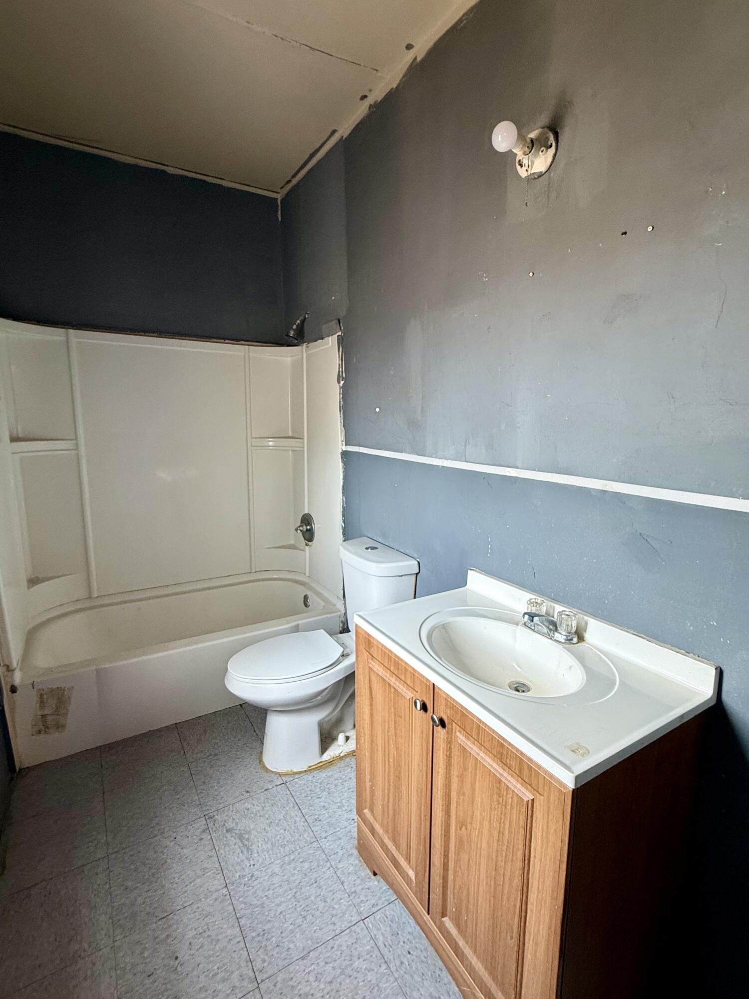 2833 East 53rd Street Lubbock, TX 79404 - Photo 13 of 30 a bathroom with a sink a toilet and shower