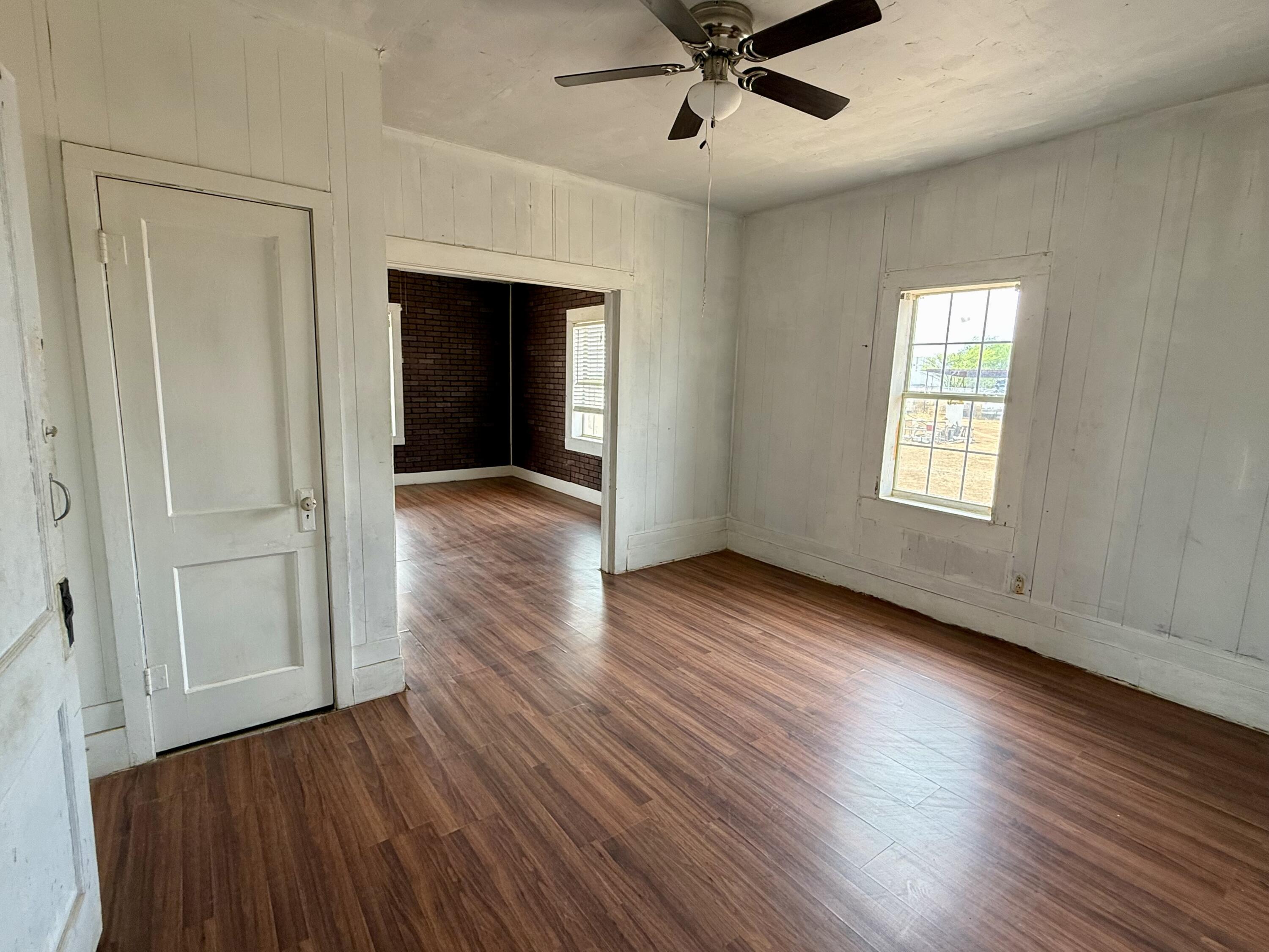 2833 East 53rd Street Lubbock, TX 79404 - Photo 14 of 30 wooden floor in an empty room with a window