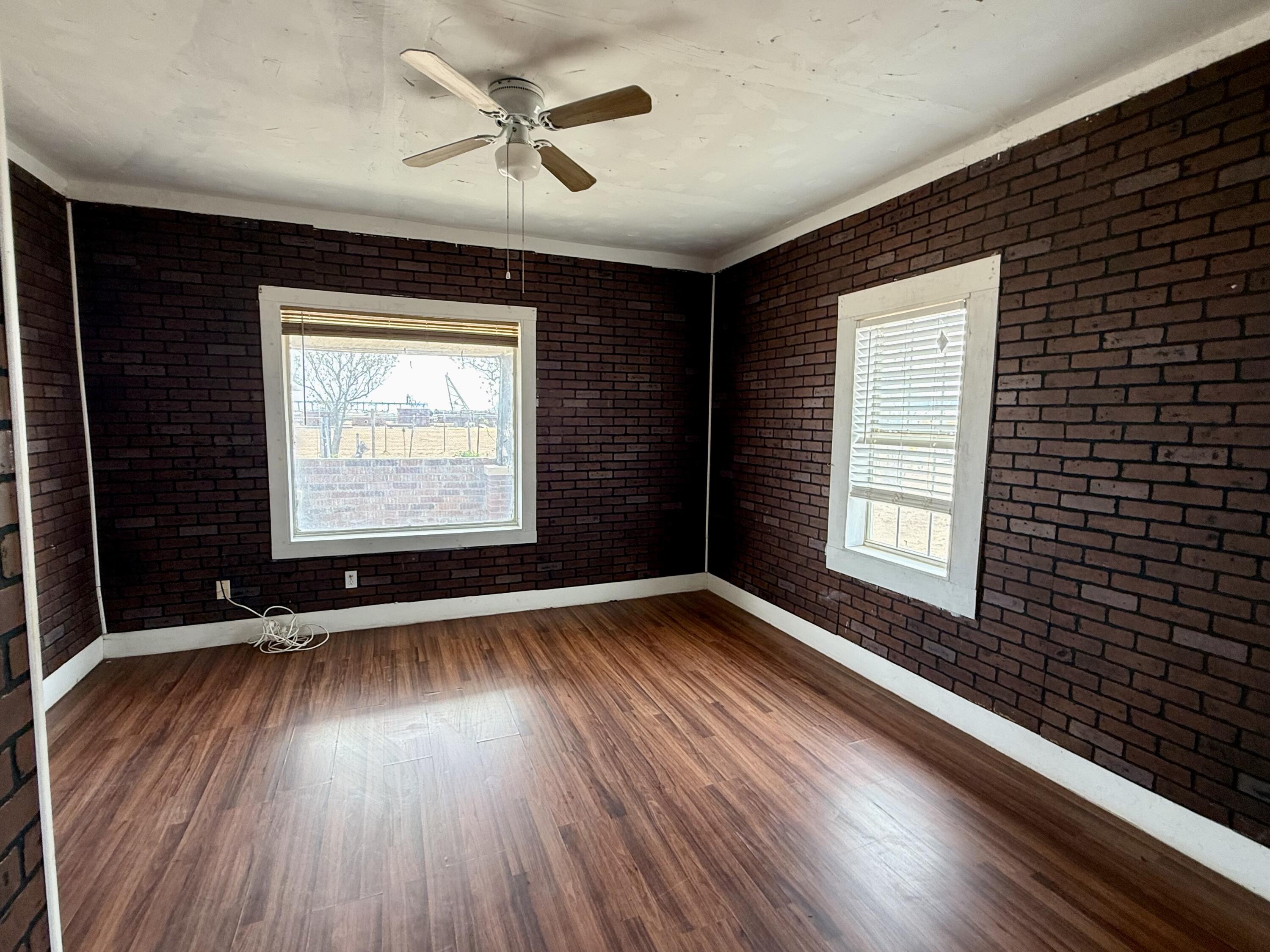 2833 East 53rd Street Lubbock, TX 79404 - Photo 15 of 30 a view of an empty room with wooden floor and a window