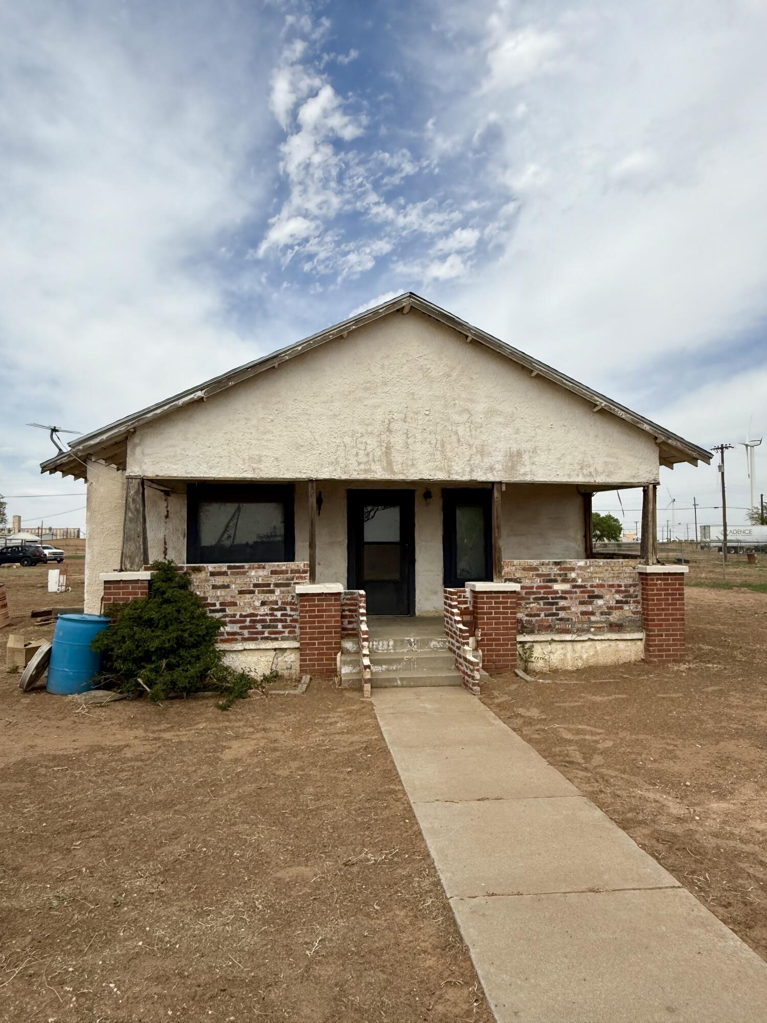 2833 East 53rd Street Lubbock, TX 79404 - Photo 3 of 30 a view of a house with sitting area and couches under an umbrella