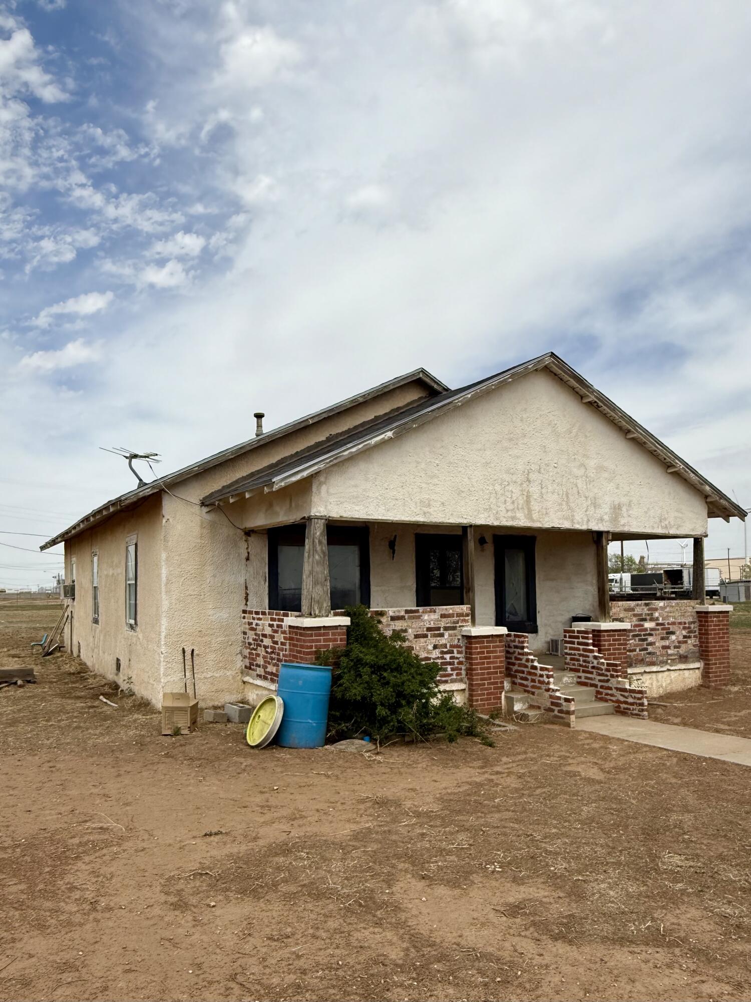 2833 East 53rd Street Lubbock, TX 79404 - Photo 4 of 30 a backyard of a house with table and chairs under an umbrella