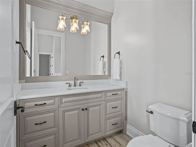 a bathroom with a granite countertop sink a mirror and a shower