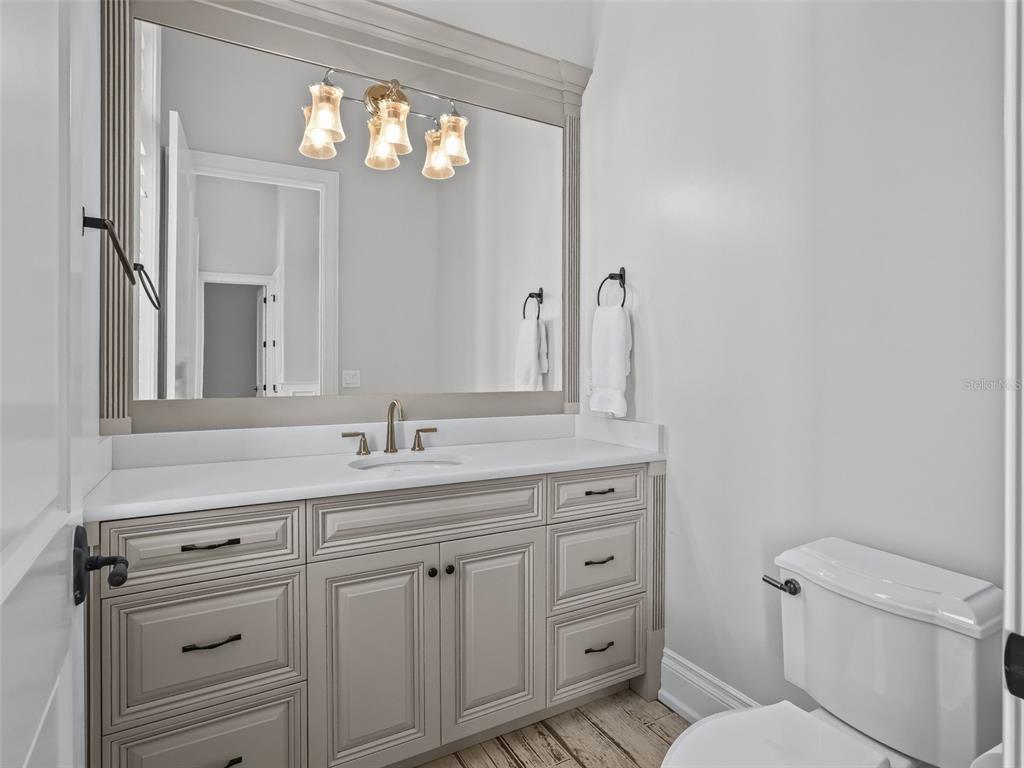 8746 Northwest 31st Lane Road Ocala, FL 34482 - Photo 29 of 89 a bathroom with a toilet a sink a vanity and mirror