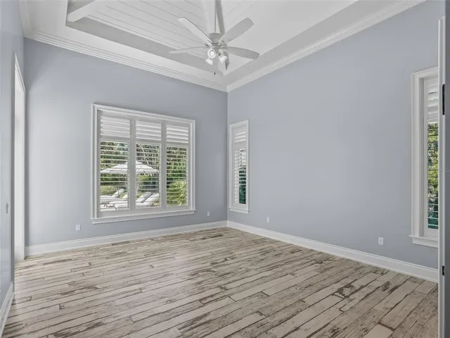 a view of an empty room with a window and bathroom