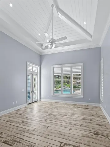 a view of a hallway with wooden floor and closet area