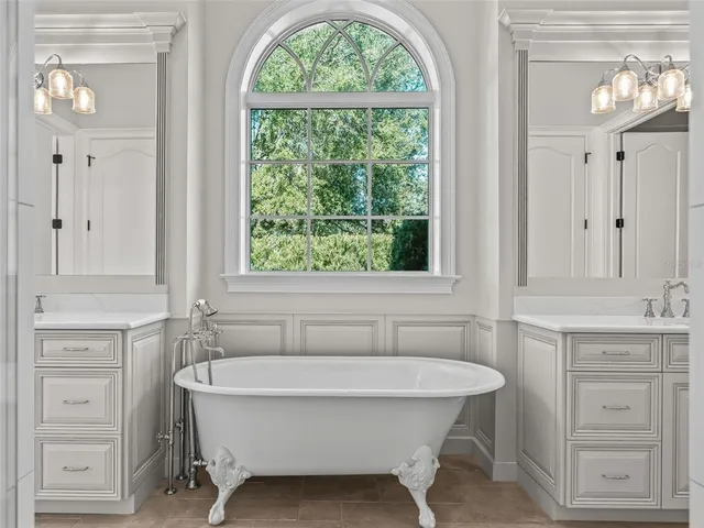 a outdoor kitchen with a stove a sink and chairs