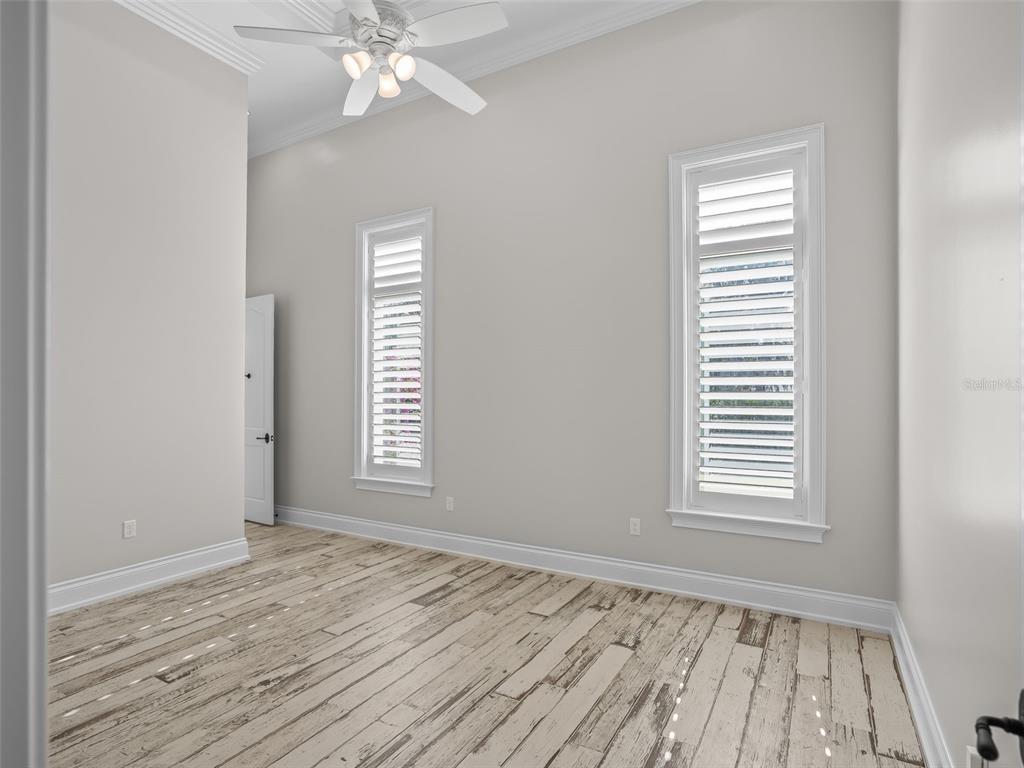 8746 Northwest 31st Lane Road Ocala, FL 34482 - Photo 42 of 89 a view of an empty room with wooden floor and a window