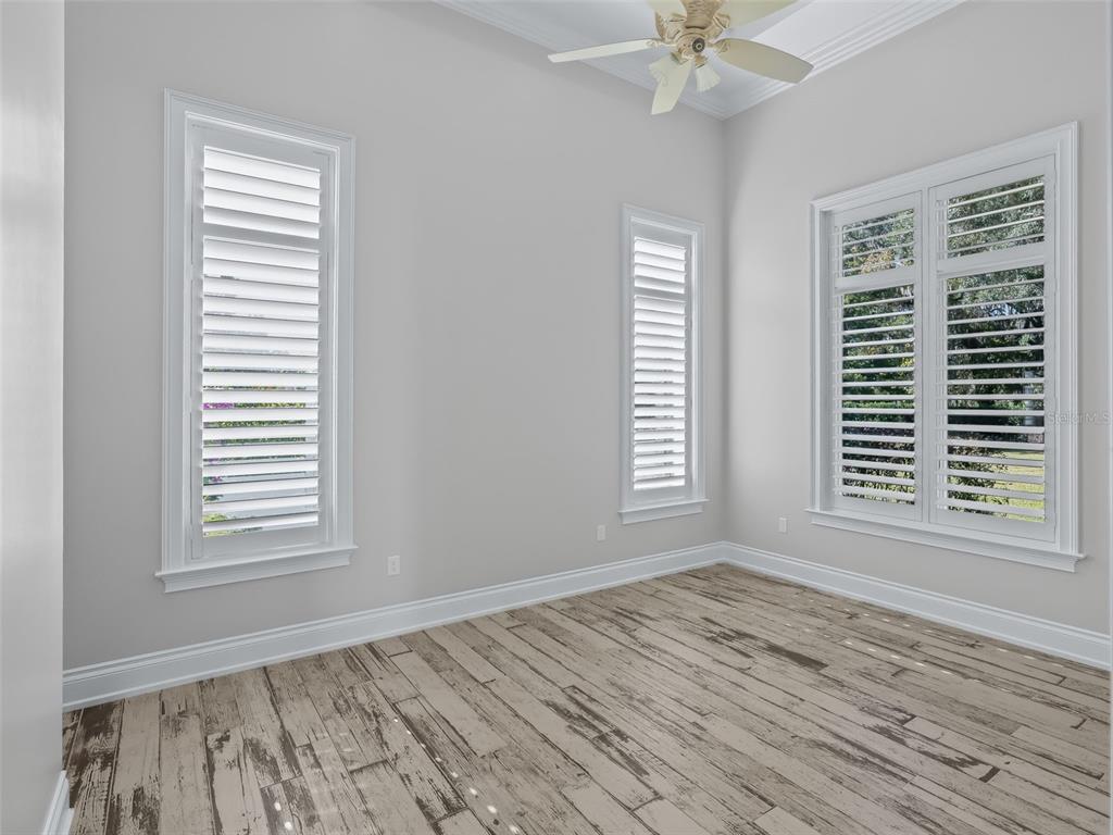 8746 Northwest 31st Lane Road Ocala, FL 34482 - Photo 46 of 89 a view of an empty room with a window and wooden floor