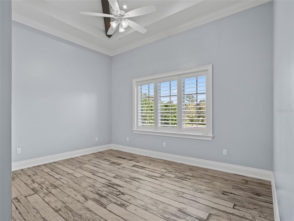8746 Northwest 31st Lane Road Ocala, FL 34482 - Photo 51 of 89 a view of empty room with wooden floor and fan