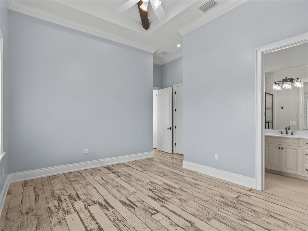 8746 Northwest 31st Lane Road Ocala, FL 34482 - Photo 53 of 89 wooden floor in an empty room with a chandelier fan