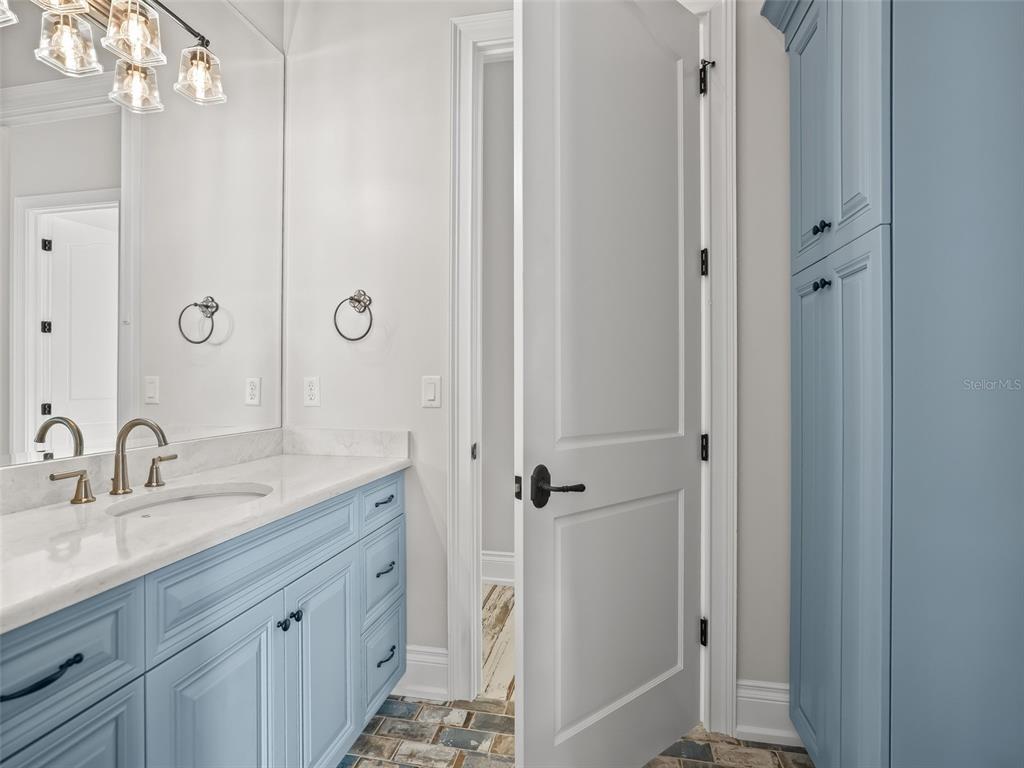 8746 Northwest 31st Lane Road Ocala, FL 34482 - Photo 55 of 89 a bathroom with a granite countertop sink a mirror and a shower