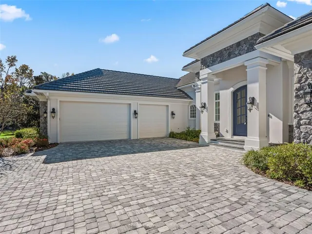 a large kitchen with kitchen island a stove a sink dishwasher a dining table and chairs with wooden floor