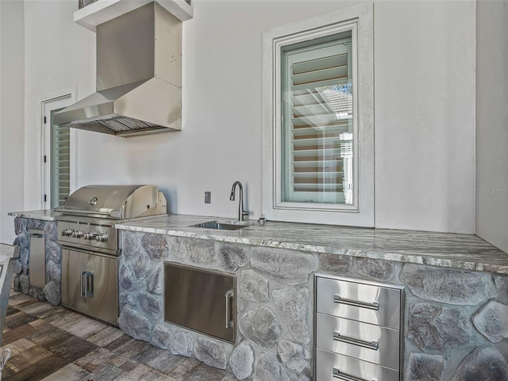 8746 Northwest 31st Lane Road Ocala, FL 34482 - Photo 71 of 89 a kitchen with stainless steel appliances granite countertop a stove and a sink