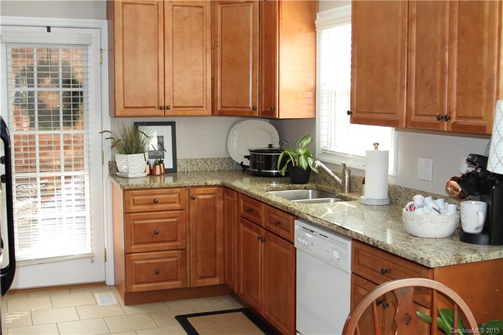 402 Stowe Road Belmont, NC 28012 - Photo 3 of 8 a kitchen with stainless steel appliances granite countertop a sink dishwasher and cabinets with wooden floor